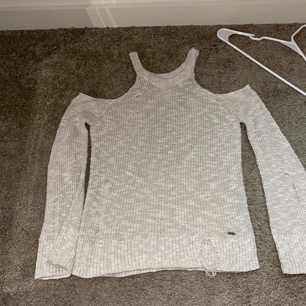 Distressed cold shoulder sweater